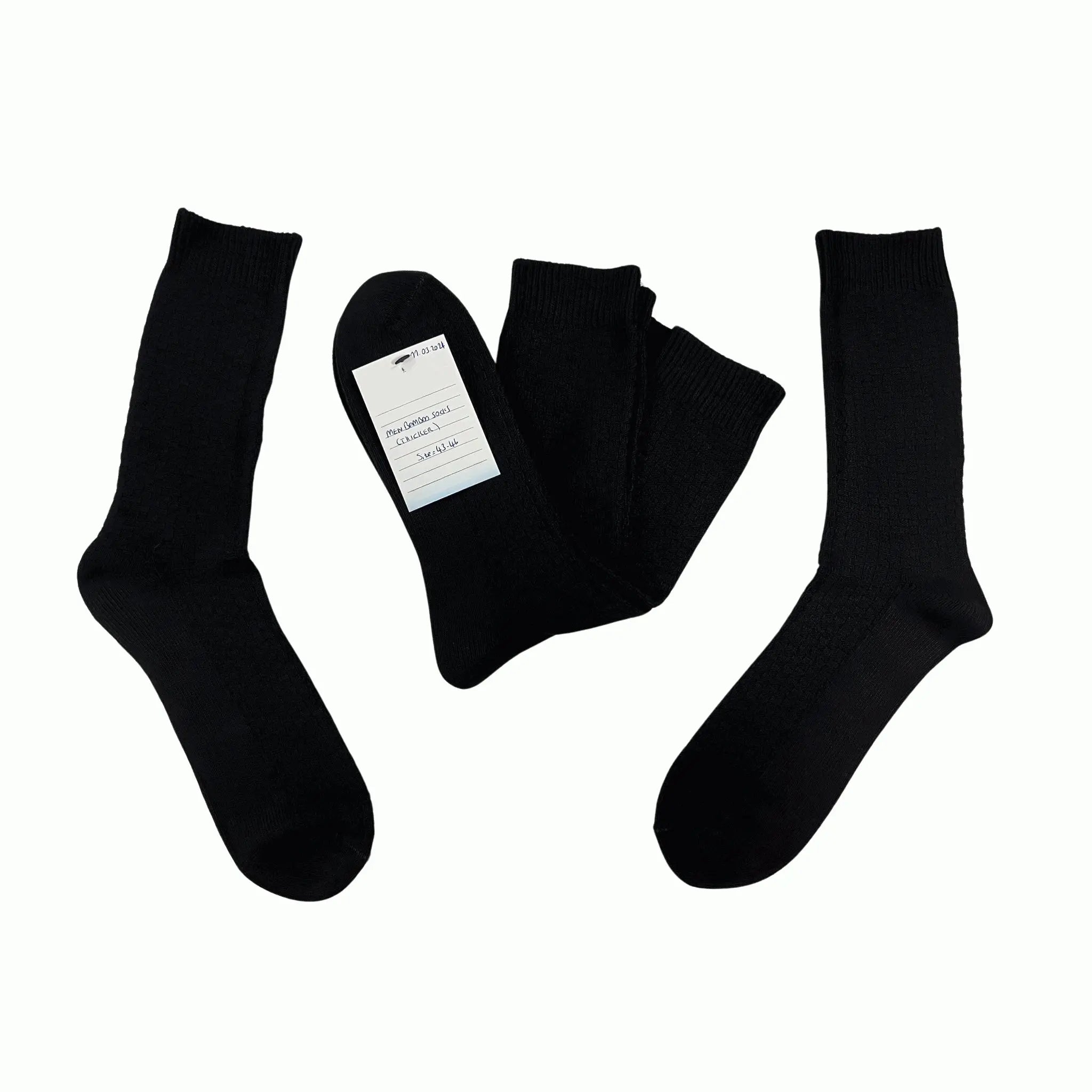 A pair of black bamboo mid-weight boot socks displayed on a white background, along with a folded sock showing the texture and a tag indicating the brand.