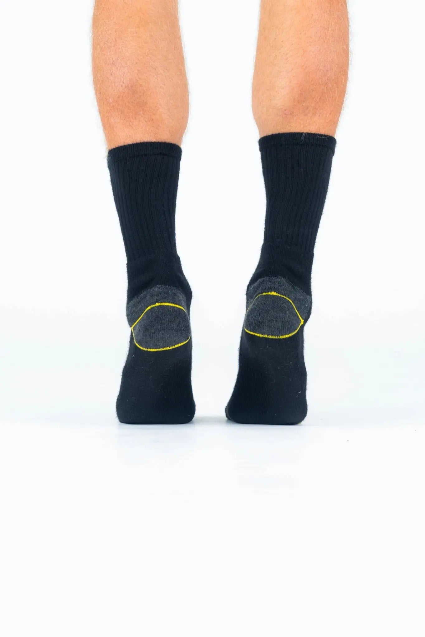 Black bamboo work socks with yellow heel detail, shown worn from the back, reinforced and breathable for heavy-duty use