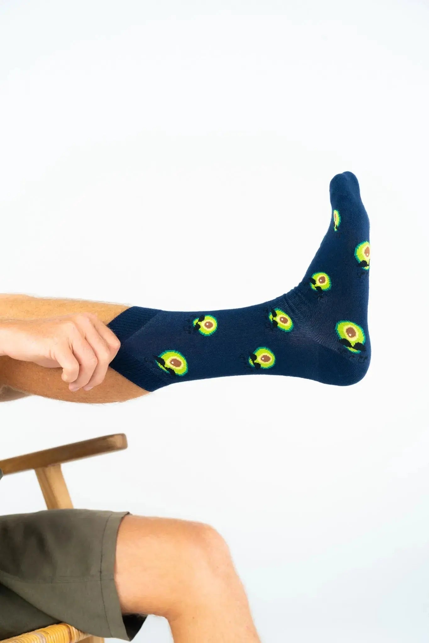 Navy bamboo socks with avocado pattern shown stretched, soft comfortable sustainable socks