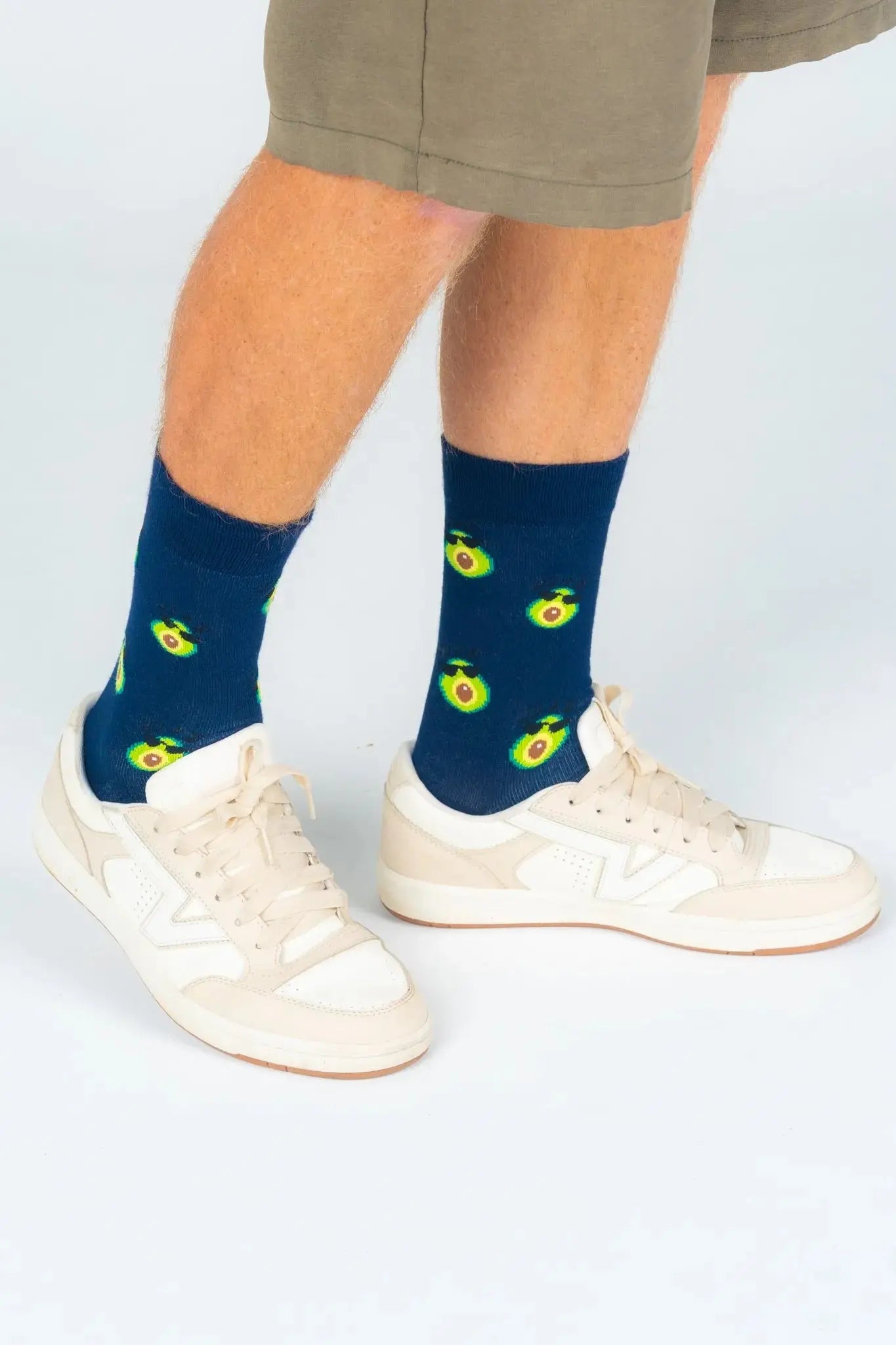 Navy bamboo socks featuring fun avocado print, worn with sneakers, comfortable sustainable fashion