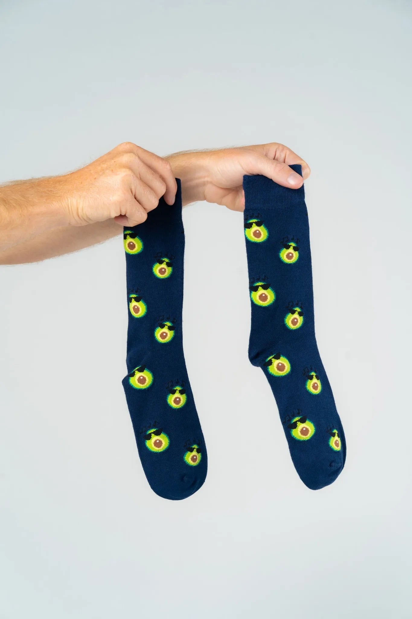 Pair of navy bamboo socks with playful avocado print, soft comfortable eco-friendly socks