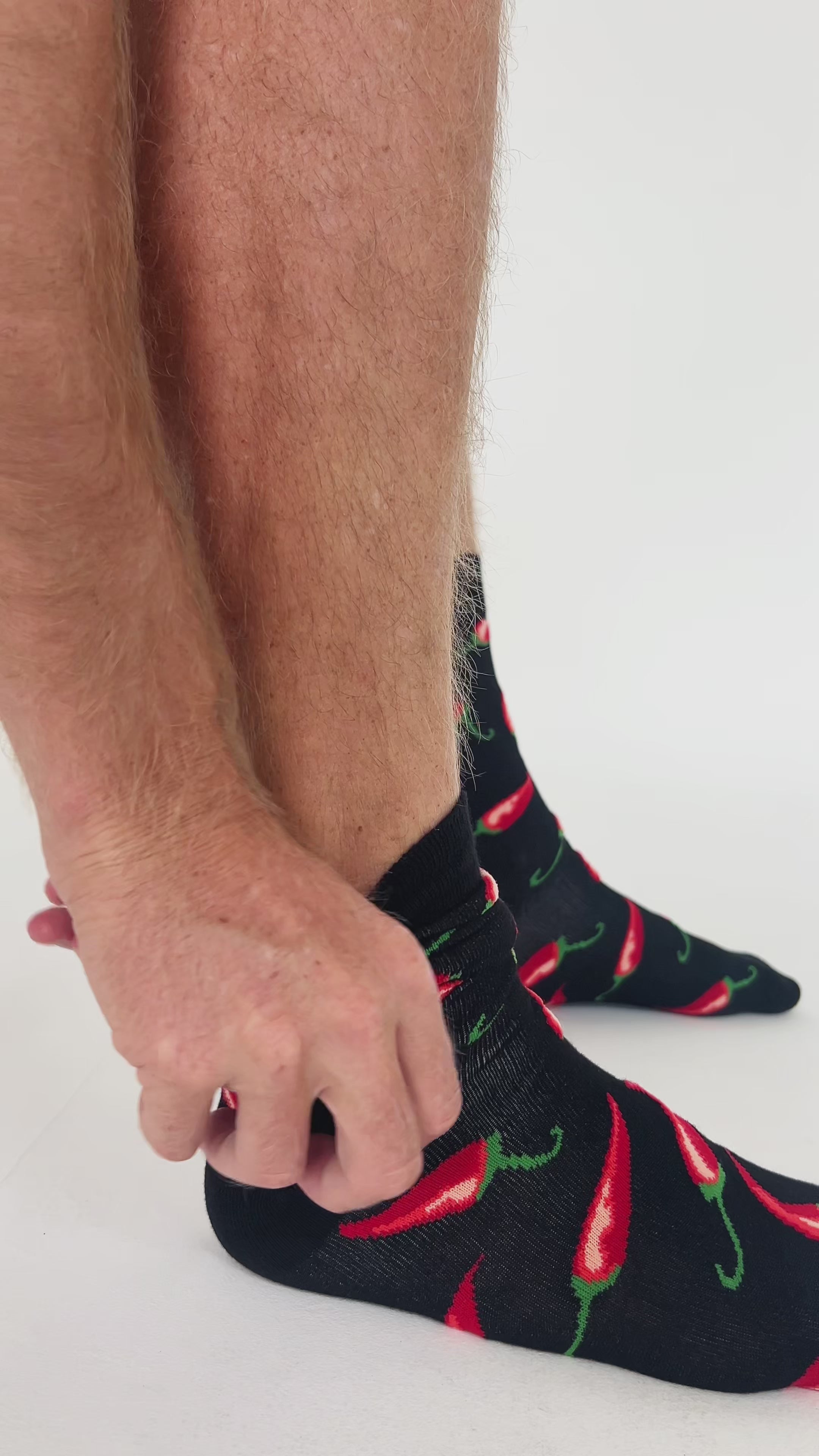 Video of man putting on chilli print bamboo socks. Soft, breathable, and designed for everyday comfort with bold style.