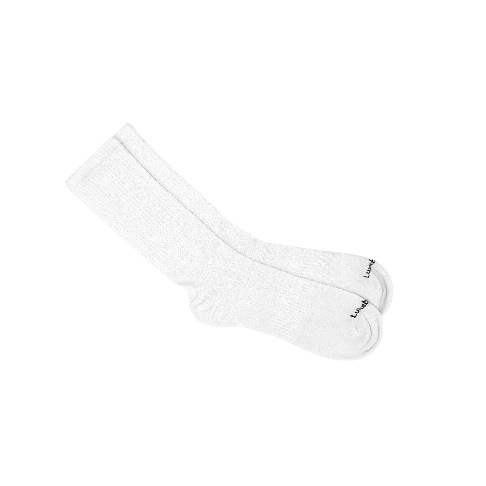 White ribbed bamboo crew socks with Luxebamboo logo on white background
