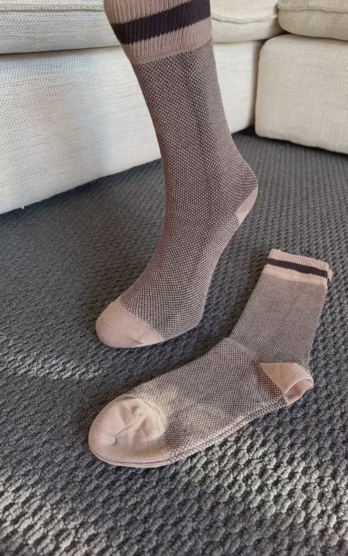 Video showing close-up zoom of brown ribbed bamboo and cotton crew socks with contrast heel and toe to highlight fabric texture